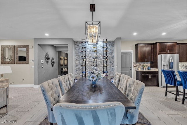 dining room featuring baseboards and recessed lighting