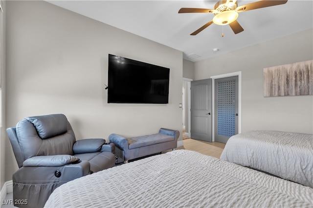 bedroom featuring light wood-style floors, ceiling fan, and baseboards