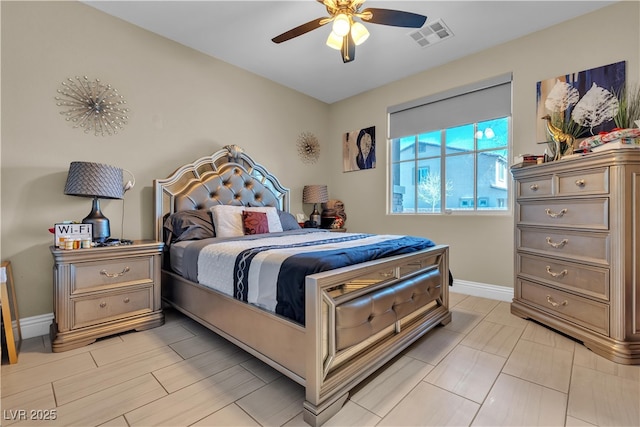 bedroom featuring ceiling fan, visible vents, and baseboards