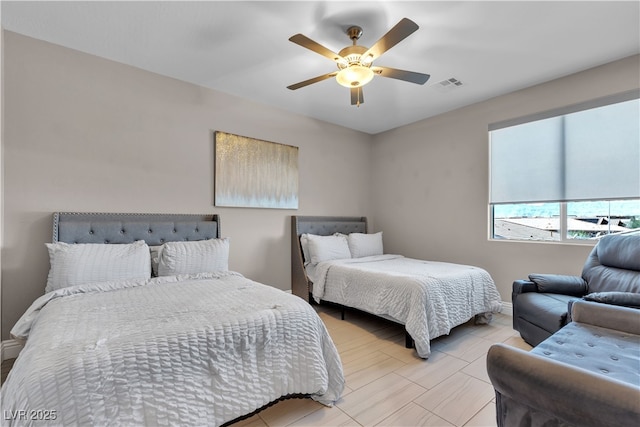 bedroom with ceiling fan, visible vents, and baseboards