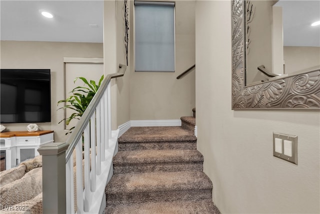 stairway with baseboards and recessed lighting