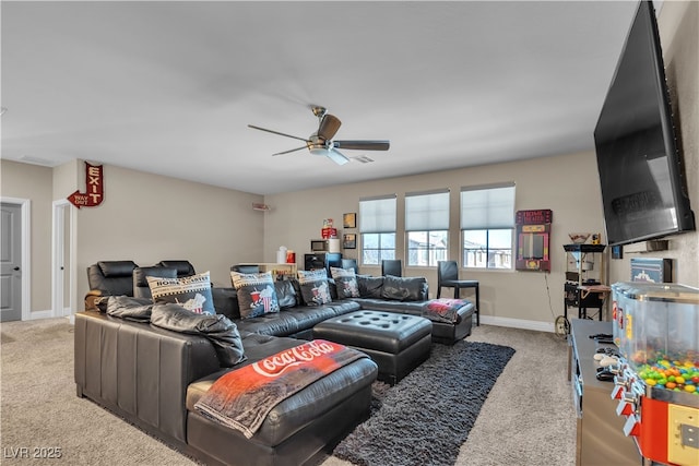 carpeted living room featuring ceiling fan and baseboards