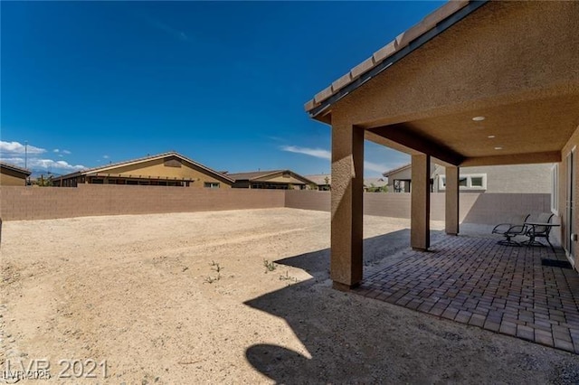 view of yard featuring a patio area and a fenced backyard