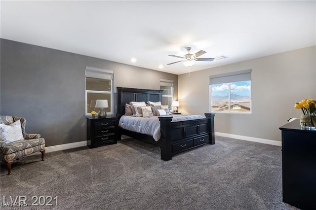 bedroom with ceiling fan, visible vents, baseboards, and dark colored carpet