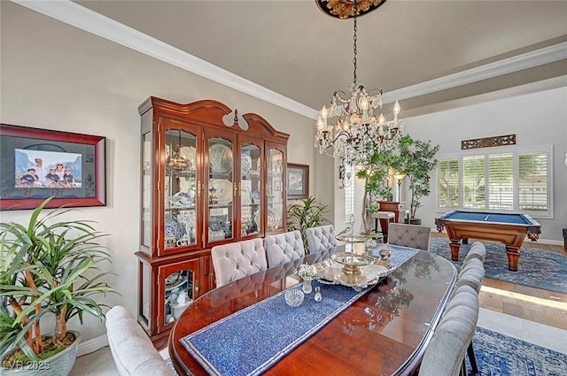 dining space featuring baseboards, ornamental molding, a chandelier, and pool table