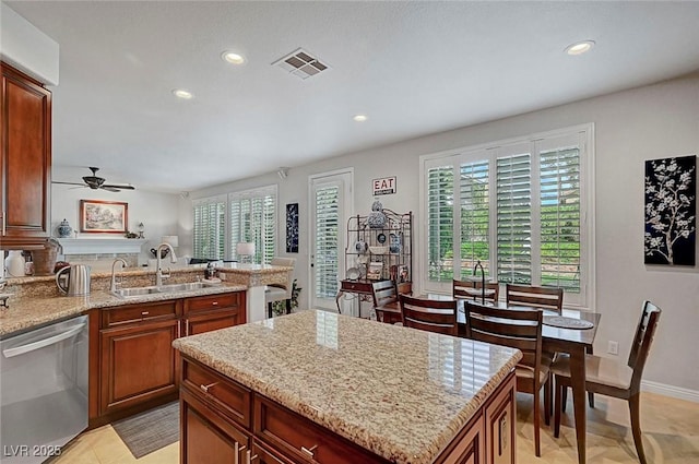 kitchen with a sink, a wealth of natural light, visible vents, and stainless steel dishwasher