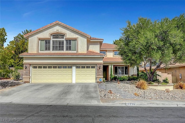 view of front of house with concrete driveway, an attached garage, a tiled roof, and stucco siding