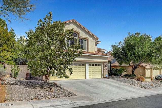 view of front of property with a garage, concrete driveway, and stucco siding