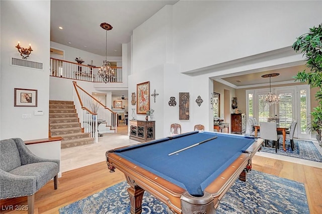 game room with a chandelier, billiards, visible vents, a towering ceiling, and light wood finished floors