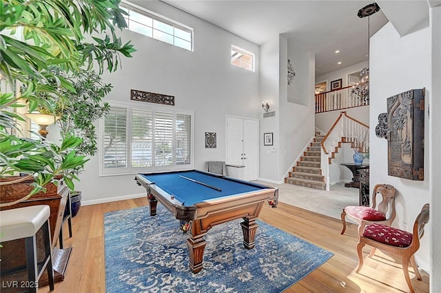 rec room with billiards, a high ceiling, baseboards, and wood finished floors