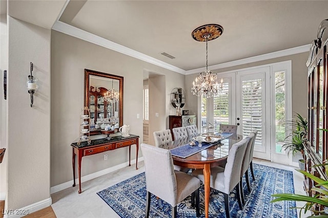 dining space featuring ornamental molding, visible vents, and a notable chandelier