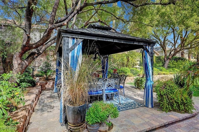 view of patio / terrace with outdoor dining area and a gazebo