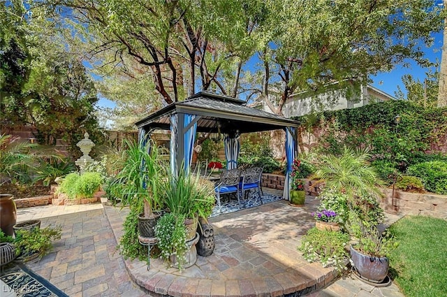 view of patio featuring fence and a gazebo