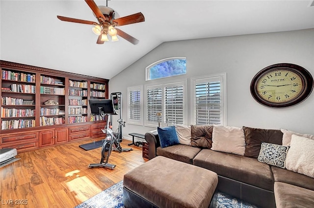 interior space with a ceiling fan, lofted ceiling, and wood finished floors