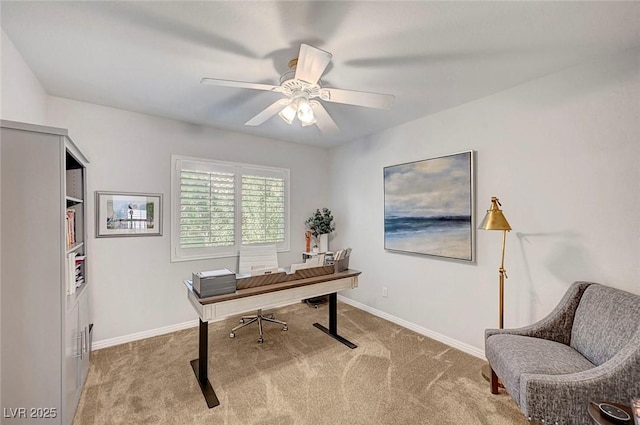 carpeted office featuring ceiling fan and baseboards