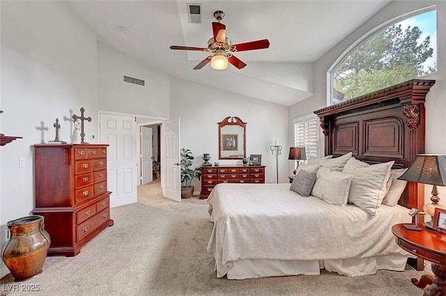 bedroom with light carpet, high vaulted ceiling, visible vents, and a ceiling fan