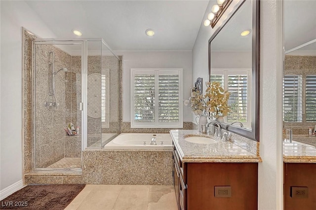 bathroom with a garden tub, a shower stall, and vanity