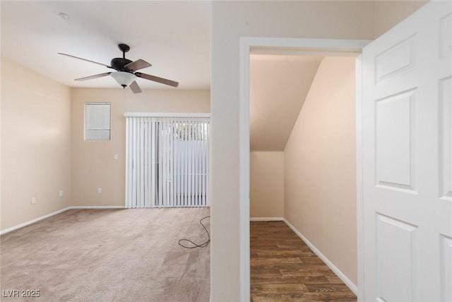 unfurnished room featuring carpet flooring, a ceiling fan, and baseboards