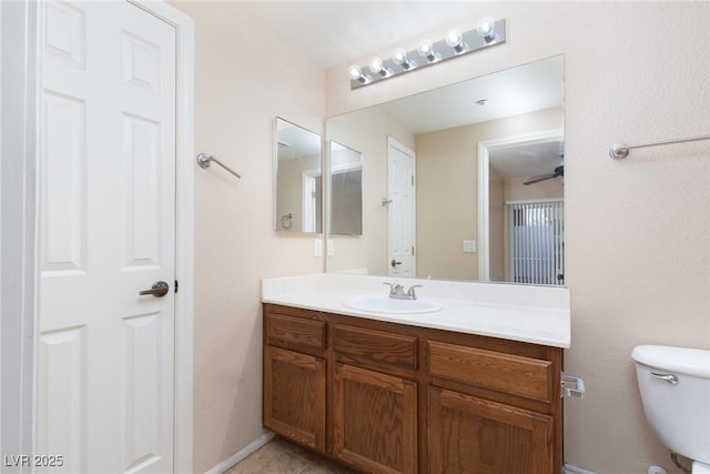 bathroom featuring toilet, tile patterned floors, and vanity