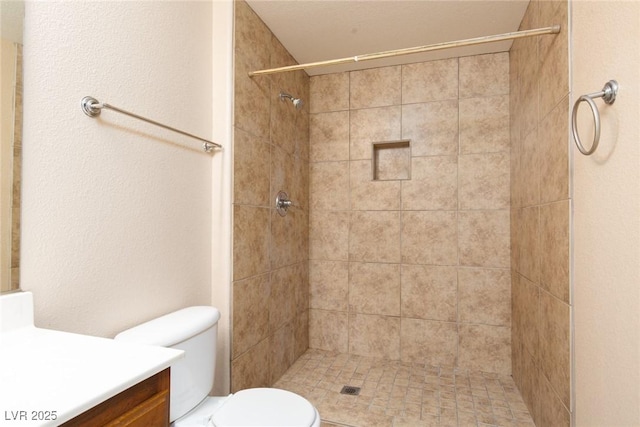 full bathroom with a stall shower, vanity, and toilet