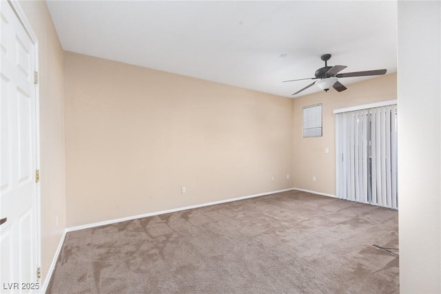 empty room with a ceiling fan, baseboards, and carpet flooring