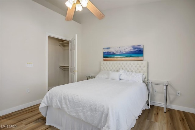 bedroom featuring ceiling fan, baseboards, and wood finished floors