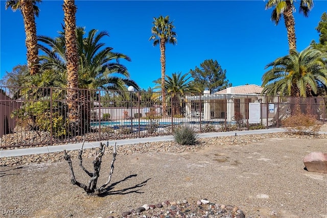 view of yard featuring fence and a community pool