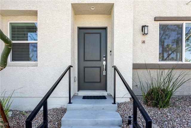 property entrance with stucco siding