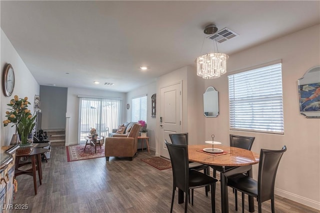 dining area with a chandelier, recessed lighting, dark wood-type flooring, visible vents, and baseboards