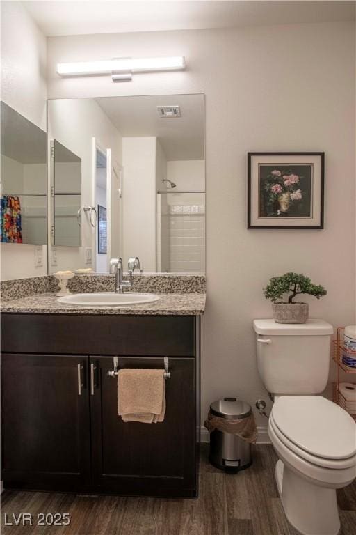 full bath with vanity, wood finished floors, and toilet