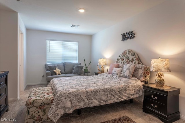 bedroom with light colored carpet, visible vents, and baseboards