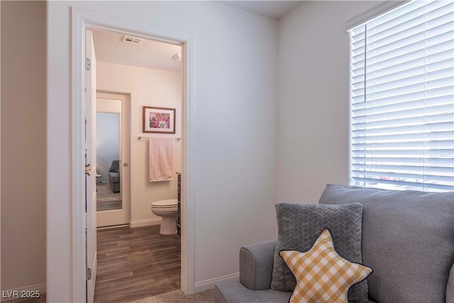 bathroom featuring baseboards, toilet, and wood finished floors