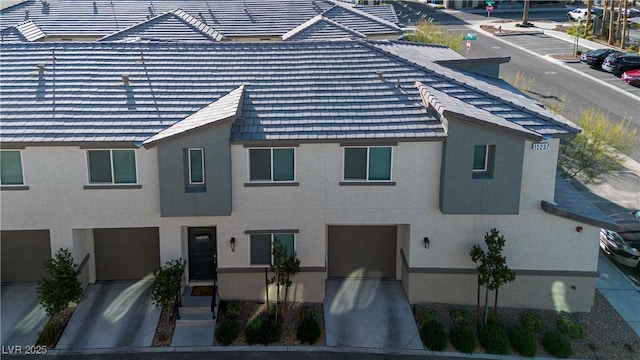 view of front of property with a tile roof and stucco siding