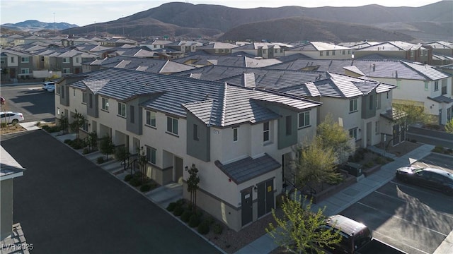 drone / aerial view featuring a residential view and a mountain view