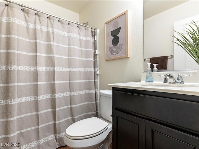 bathroom featuring toilet and vanity