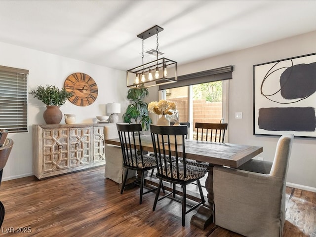 dining room featuring baseboards, visible vents, and dark wood-style flooring