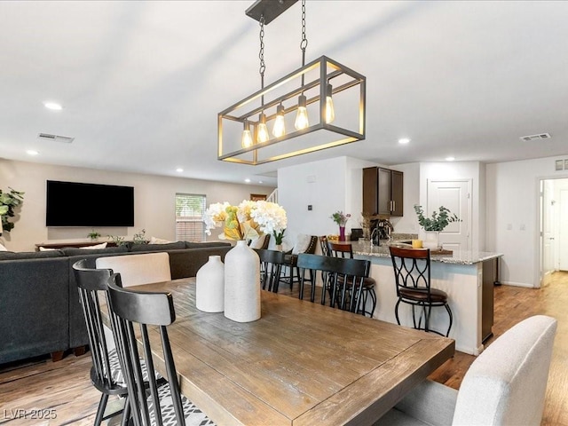 dining area with light wood-type flooring, visible vents, baseboards, and recessed lighting