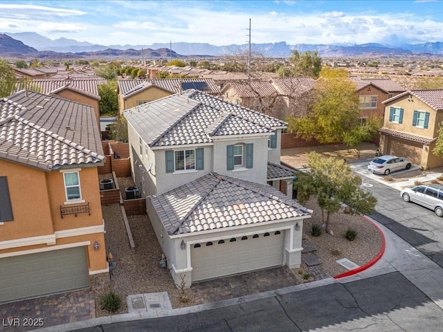 drone / aerial view featuring a residential view and a mountain view