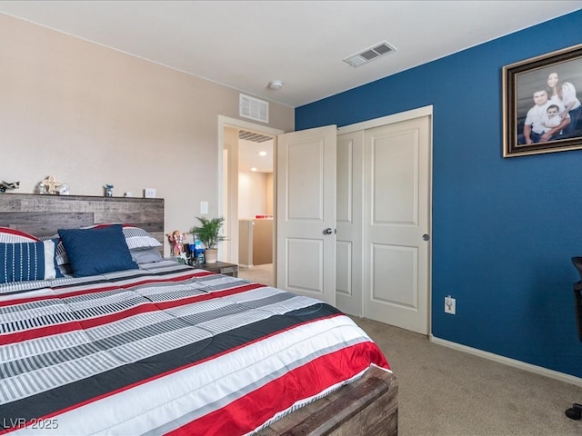 carpeted bedroom featuring a closet, visible vents, and baseboards