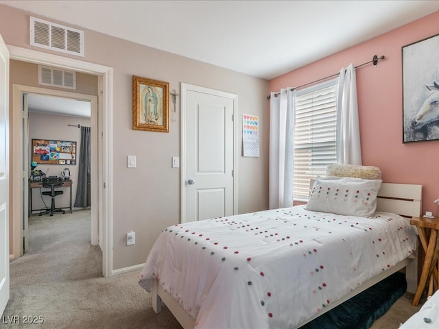 bedroom with light colored carpet, visible vents, and baseboards