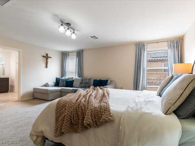 bedroom with visible vents, light carpet, baseboards, and multiple windows