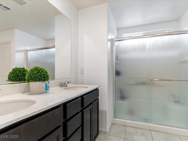 full bathroom featuring a shower stall, visible vents, and a sink