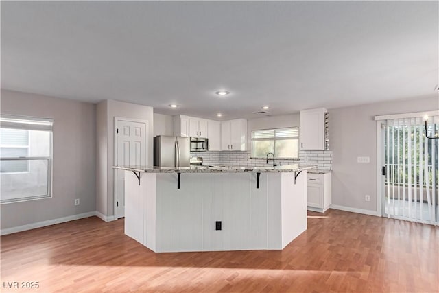 kitchen featuring a healthy amount of sunlight, stainless steel appliances, and a sink