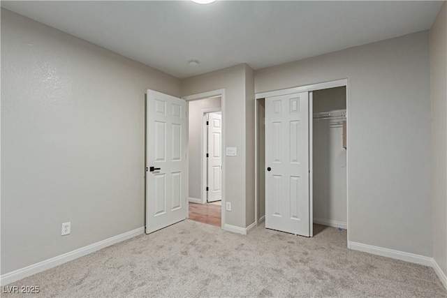 unfurnished bedroom featuring a closet, carpet, and baseboards