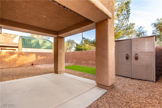 view of patio with fence and mail area