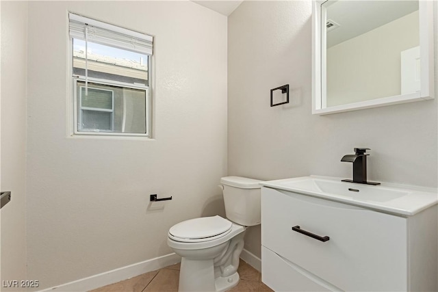 bathroom with visible vents, toilet, vanity, baseboards, and tile patterned floors