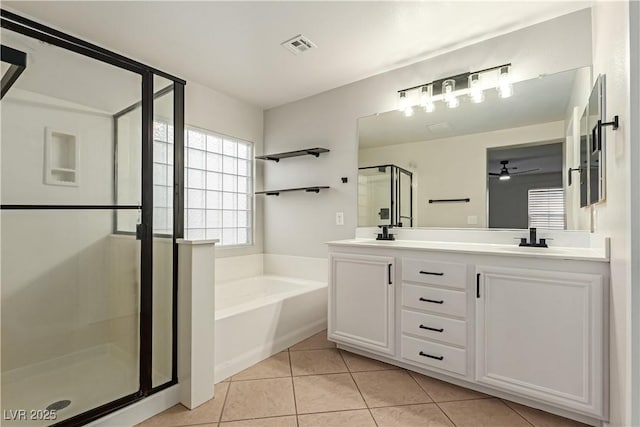 full bathroom with a garden tub, a sink, a shower stall, tile patterned floors, and double vanity