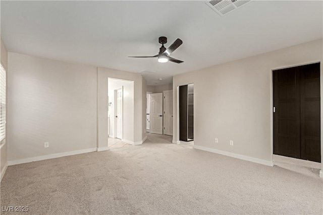 unfurnished bedroom with light carpet, a ceiling fan, visible vents, and baseboards