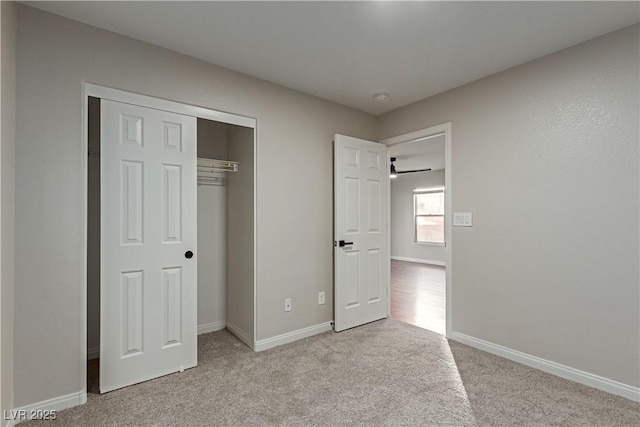 unfurnished bedroom featuring carpet floors, baseboards, and a closet