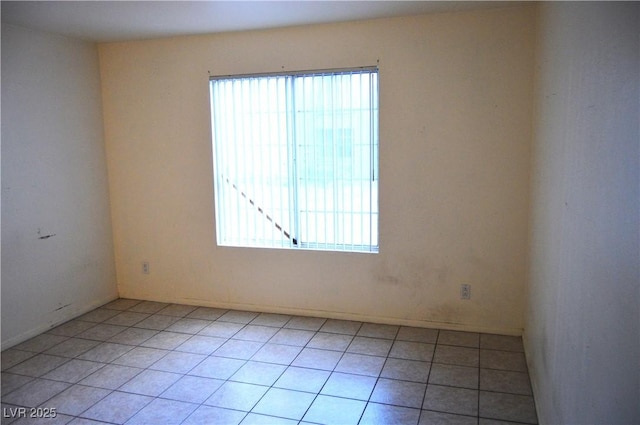 unfurnished room with light tile patterned flooring